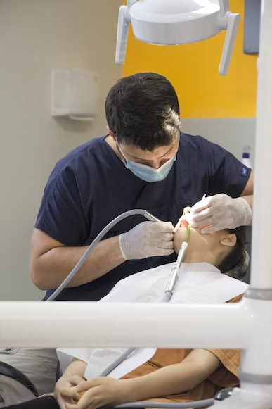 a dentist performing a dental cleaning