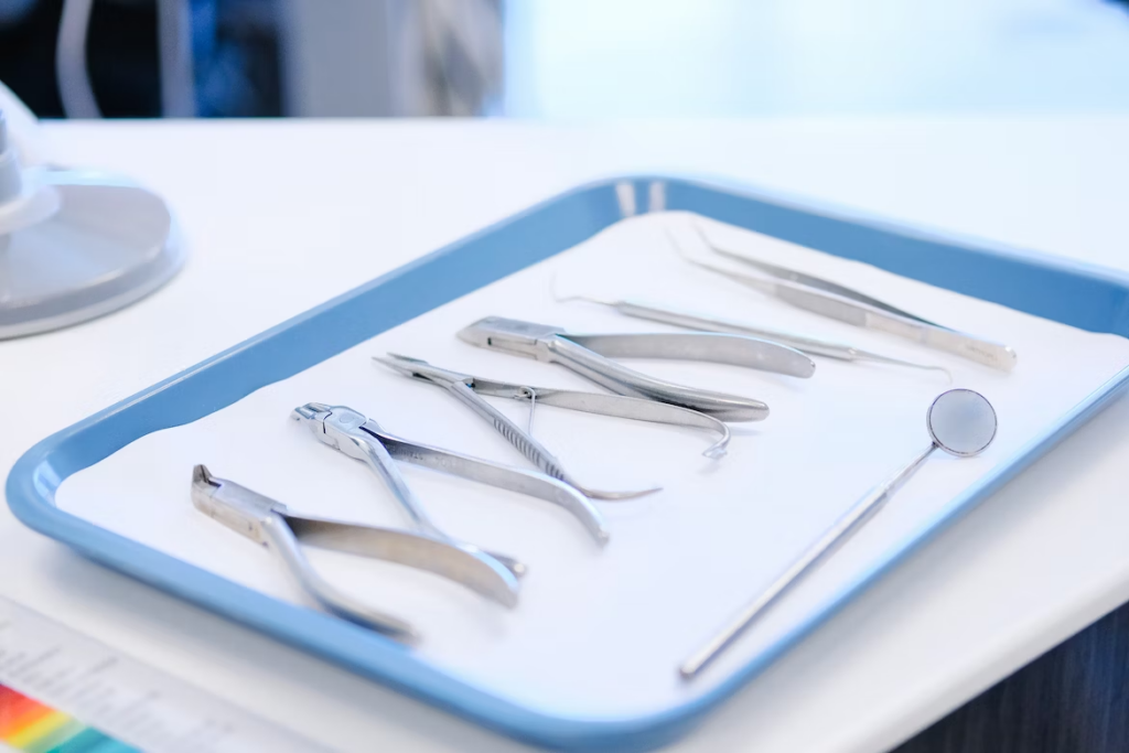 several dental tools on a blue tray