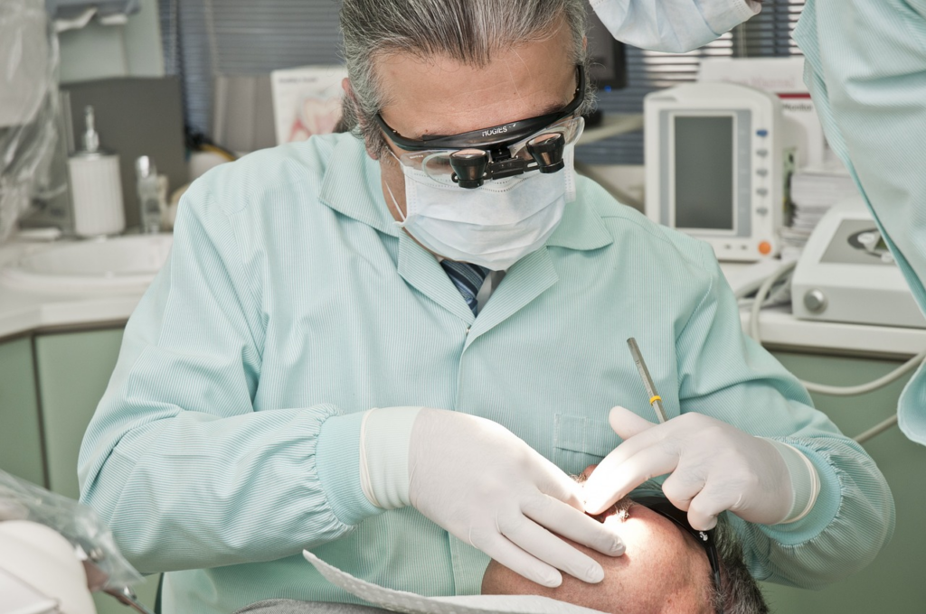 a dentist performing a dental procedure on his patient