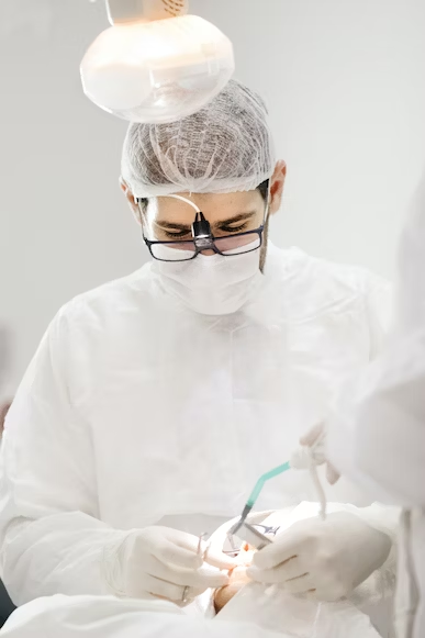 a dentist focusing intently as he perform a dental procedure